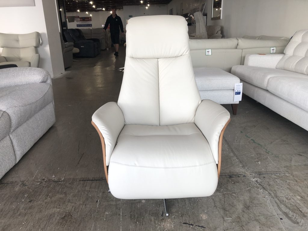 Modern pad-over-chaise cushion detail gives additional comfort & support when in recline. Choose from a black or chrome base. Full veneered side available in Light or Dark Wood. Halburg is a Manual Chair with a Manual Adjustable Footrest & Headrest for added support and comfort.